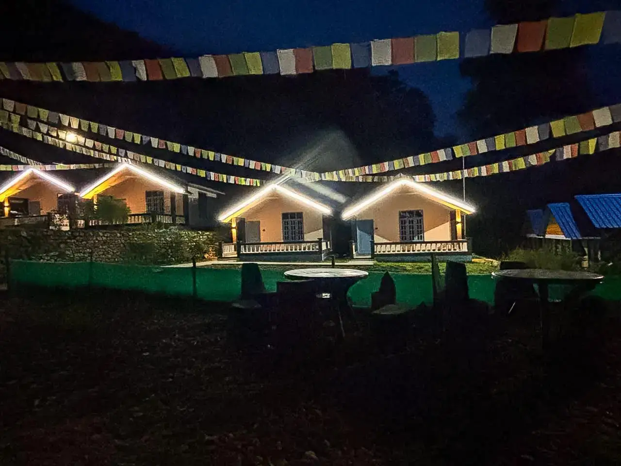 Cottages at night with illuminated prayer flags
