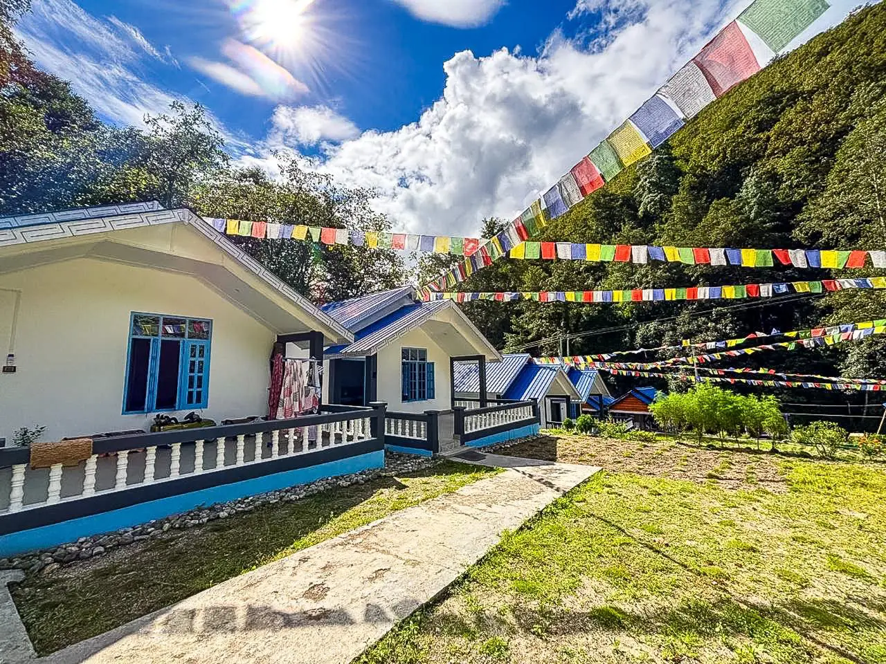 TenzinNora cottages on sunny day with mountain backdrop
